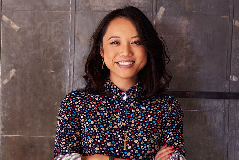 Portrait Of Female Designer Standing In Modern Office-1000x670