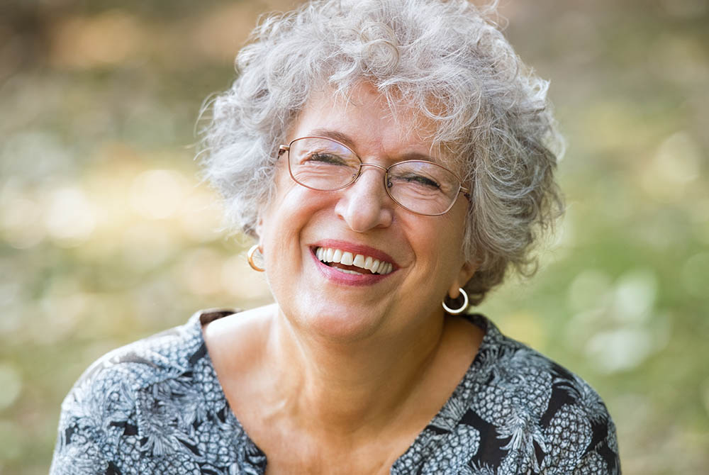 Senior woman laughing-1000x670