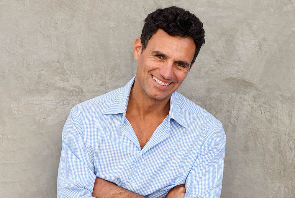 handsome mature man standing by wall-1000x670-1000x670